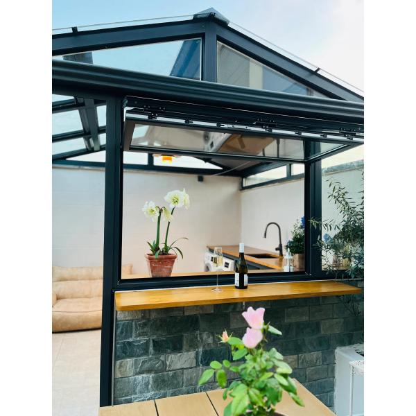 Wide-Angle Folding Window Assembly Creating Uninterrupted Garden Perspectives and Easy-Access Patio Connections